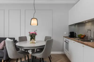 a kitchen with a white table and chairs at Wielopole17 Miro Apartment with AC in Kraków