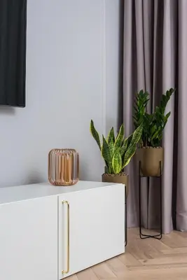 a white side table with plants in a room at Wielopole17 Miro Apartment with AC in Kraków