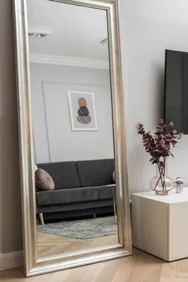 a large mirror in a living room with a couch at Wielopole17 Miro Apartment with AC in Kraków