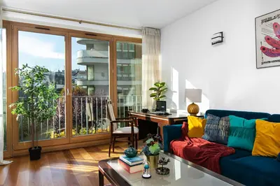 a living room with a couch and a desk and a window at Otium Old Town Angel Plaza in Kraków