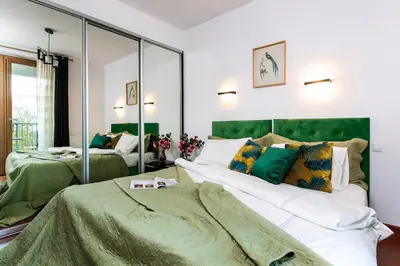 a bedroom with two beds and a large mirror at Otium Old Town Angel Plaza in Kraków