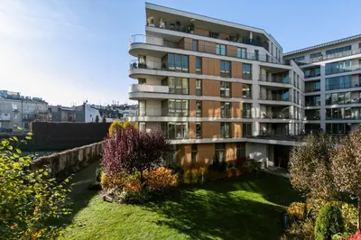 a large apartment building with a garden in front of it at Otium Old Town Angel Plaza in Kraków