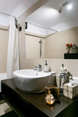 a bathroom with a white sink and a mirror at Otium Old Town Angel Plaza in Kraków