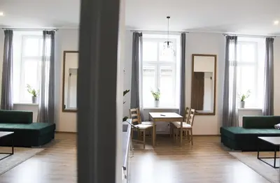 a living room with green furniture and a table at Apartament Mickiewicza in Wadowice