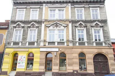 a large building with many windows on a street at Apartament Mickiewicza in Wadowice