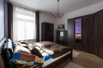 a bedroom with a bed and a tv and a window at Komfortowy apartament - obok Rynku in Kraków