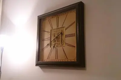 a picture of a clock on a wall at Komfortowy apartament - obok Rynku in Kraków