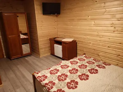 a door to a room with a bed in a cabin at Willa Wiktoria in Zawoja