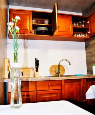 a bedroom with a bed and a desk and a window at Willa Wiktoria in Zawoja