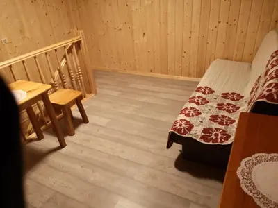 a room with two beds in a log cabin at Willa Wiktoria in Zawoja