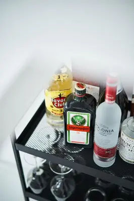 a shelf with alcohol and other items on it at UNIQUE DESIGN Loft in middle of CENTRE of OLD TOWN with Netflix in Kraków