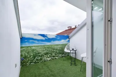 a room with a window with a view of a field of flowers at UNIQUE DESIGN Loft in middle of CENTRE of OLD TOWN with Netflix in Kraków