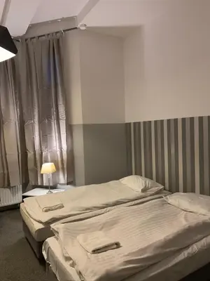 a bedroom with two beds and a window at Cracow bb in Kraków