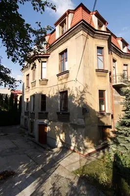 an old house is sitting on the side of a street at Cracow bb in Kraków