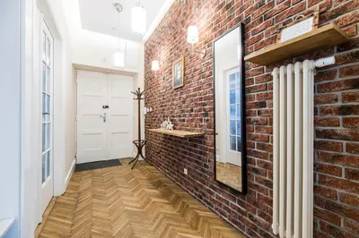 a brick hallway with a mirror and a brick wall at Native Apartments Batorego 7- Bardzo ciche i spokojne miejsce in Kraków