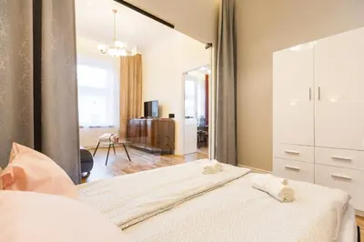 a bedroom with a large mirror next to a bed at Vintage Podzamcze Apartment in Kraków