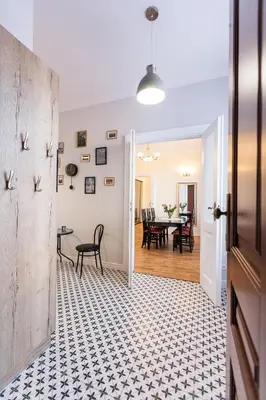 an open door to a dining room with a table at Vintage Podzamcze Apartment in Kraków