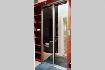 a glass door in a room with a bathroom at Bright&comfy apt -few min to Main Square in Kraków
