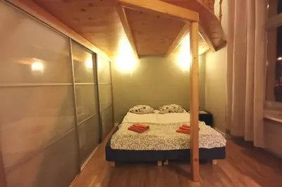 a small bedroom with a bed with a canopy at Bright&comfy apt -few min to Main Square in Kraków