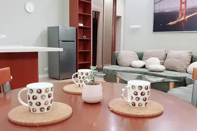 a living room with three coffee cups on a table at Bright&comfy apt -few min to Main Square in Kraków