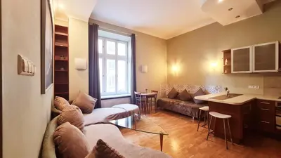 a living room with a couch and a table at Bright&comfy apt -few min to Main Square in Kraków