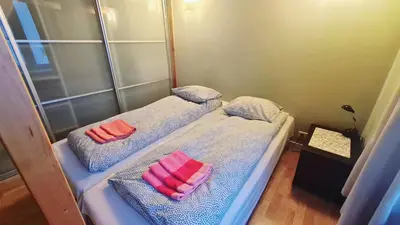 two beds in a room with pink pillows on them at Bright&comfy apt -few min to Main Square in Kraków