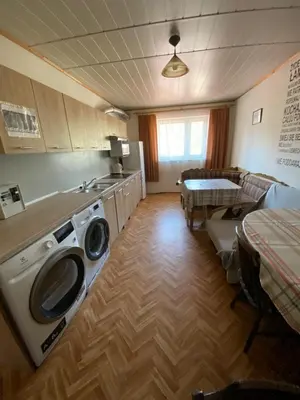a kitchen with a washing machine in the middle of a room at REKLINIEC in Myślenice