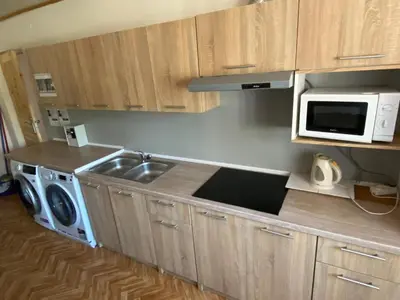 a kitchen with a sink and a microwave at REKLINIEC in Myślenice