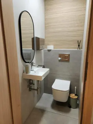 a bathroom with a sink and a toilet and a mirror at REKLINIEC in Myślenice