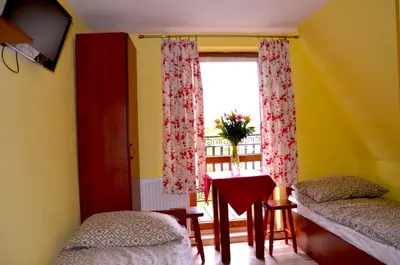 a bedroom with two beds and a window at Ośrodek Wypoczynkowo-Szkoleniowy HALNY in Zawoja