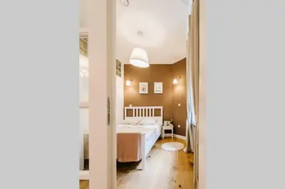a bedroom with a bed and a mirror at Old Town Apartment DeLux Kraków in Kraków