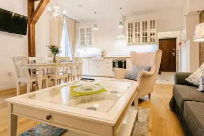 a living room with a couch and a table at Old Town Apartment DeLux Kraków in Kraków