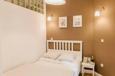 a small bedroom with a white bed in a room at Old Town Apartment DeLux Kraków in Kraków