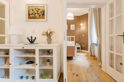 a room with a white cabinet with flowers in it at Old Town Apartment DeLux Kraków in Kraków