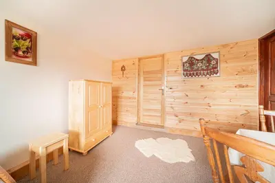 a room with a wooden wall in a house at Dom na Turystycznej in PyzÃ³wka