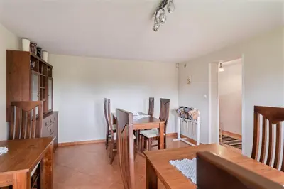 a kitchen and dining room with a table and chairs at Dom na Turystycznej in PyzÃ³wka