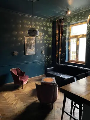 a living room with a couch and a table at HOUSEHOST Apartment III: Podbrzezie Street in Kraków