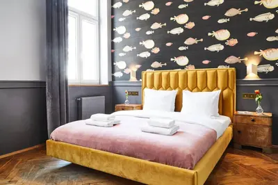 a bedroom with a large bed with towels on it at HOUSEHOST Apartment III: Podbrzezie Street in Kraków