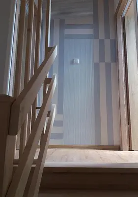 a stairway leading to a blue door in a room at Apartamenty-Obok in Zator