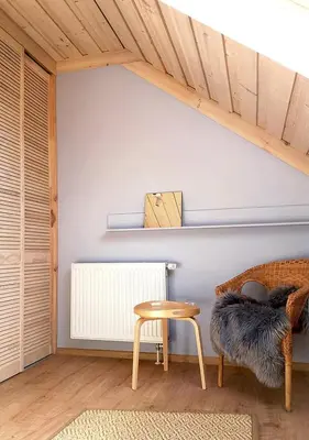 a living room with a table and a chair at Apartamenty-Obok in Zator