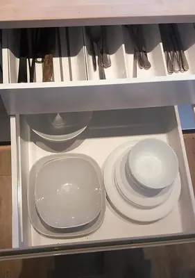 a shelf with plates and utensils in a kitchen at Apartamenty-Obok in Zator