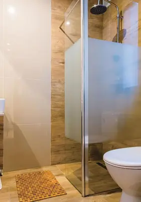 a bathroom with a shower and a toilet at Apartamenty-Obok 1 in Zator