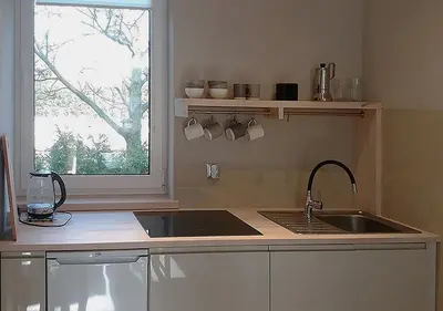 a kitchen with a sink and a window at Apartamenty-Obok 1 in Zator