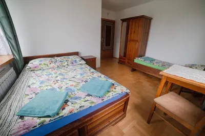 a bedroom with a bed and a desk and a table at Wiśniowy Gaj in Ujanowice