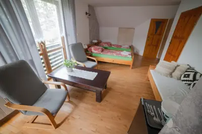 a living room with a couch and a table at Wiśniowy Gaj in Ujanowice