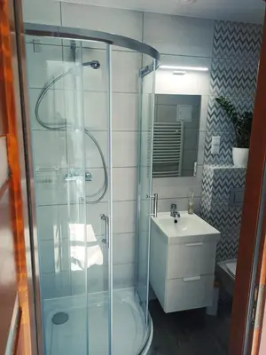 a bathroom with a glass shower and a sink at ZŁOTA PASIEKA Zator Przeciszów in Przeciszów