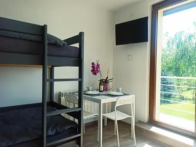 a room with a table and a bunk bed at ZŁOTA PASIEKA Zator Przeciszów in Przeciszów