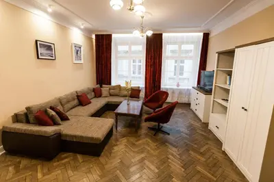 a living room with a couch and a table at Vintage Poselska Apartment in Kraków