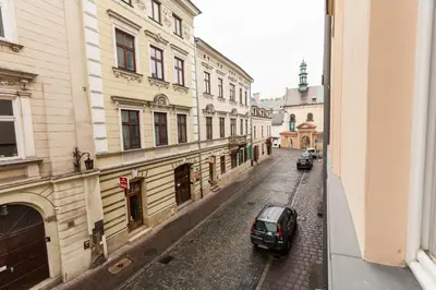 a car parked on a street next to buildings at Vintage Poselska Apartment in Kraków