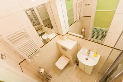 a small bathroom with a toilet and a sink at Vintage Poselska Apartment in Kraków